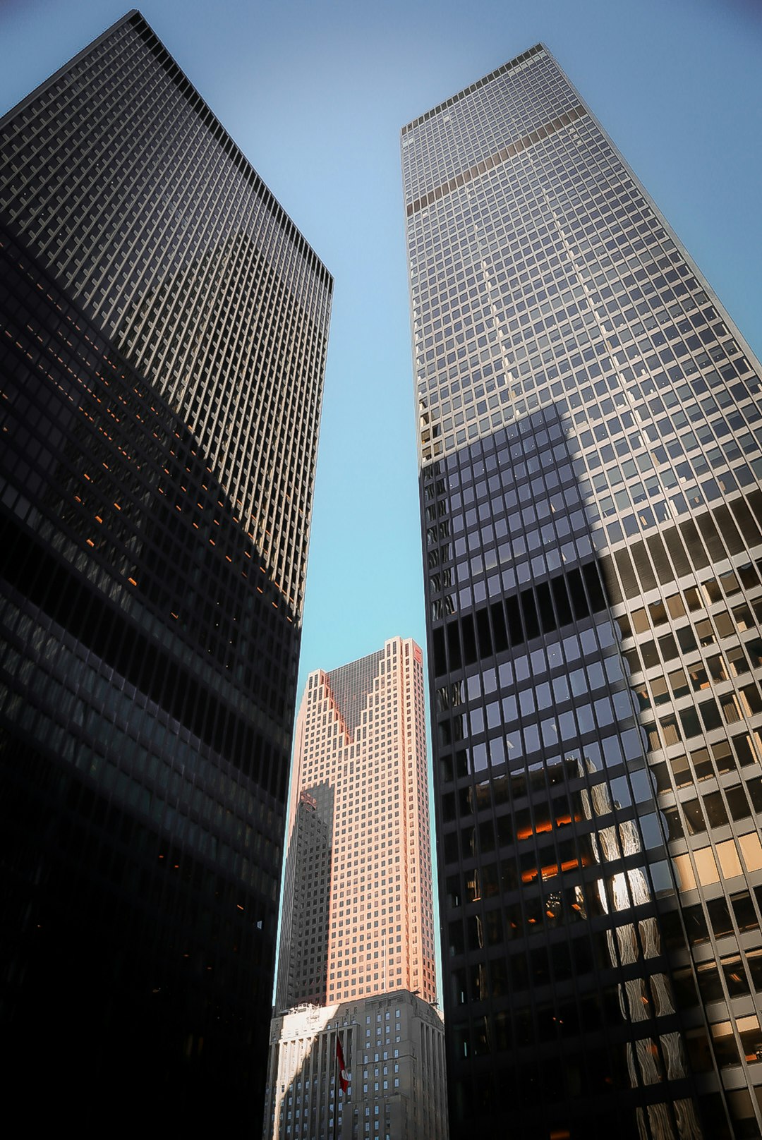 why-choose-us modern-skyscrapers-reaching-towards-a-clear-blue-sky-jqqxdb-igs0